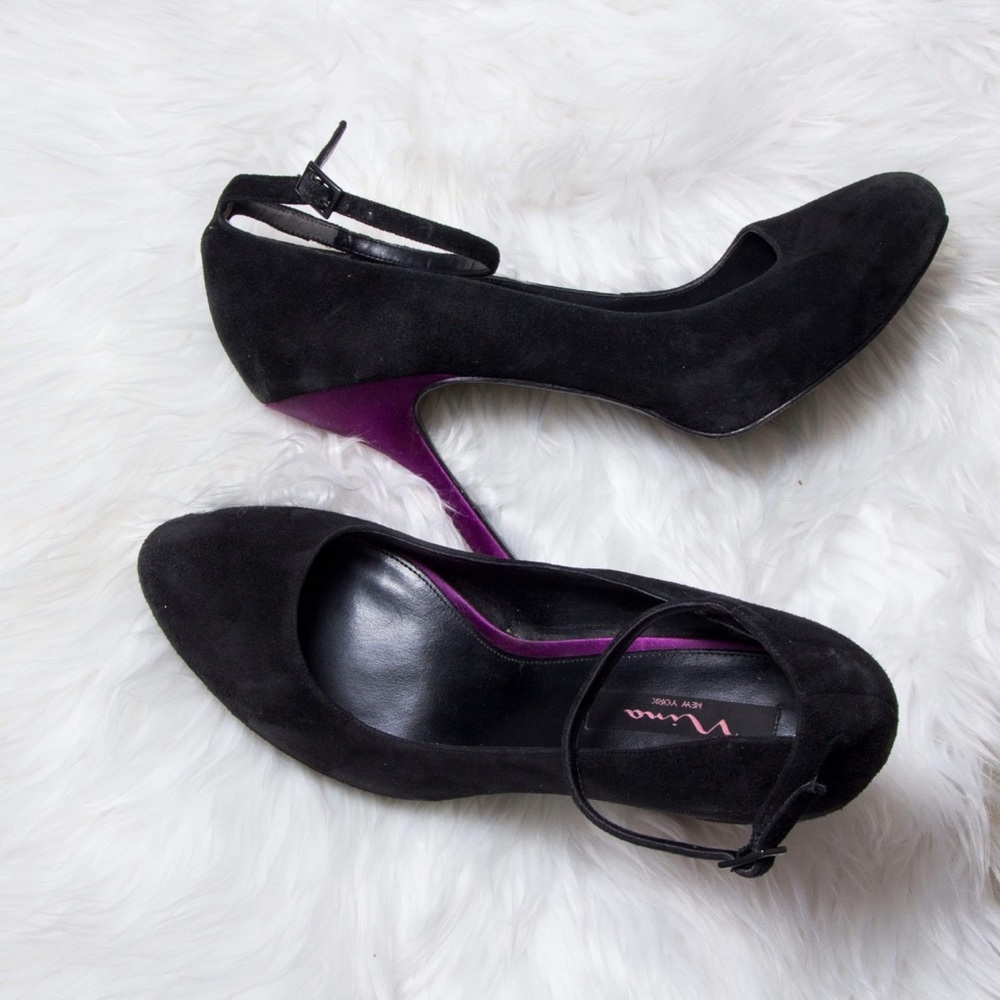 Black suede shoes with purple heel.